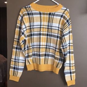 A yellow sweater, size adult small.